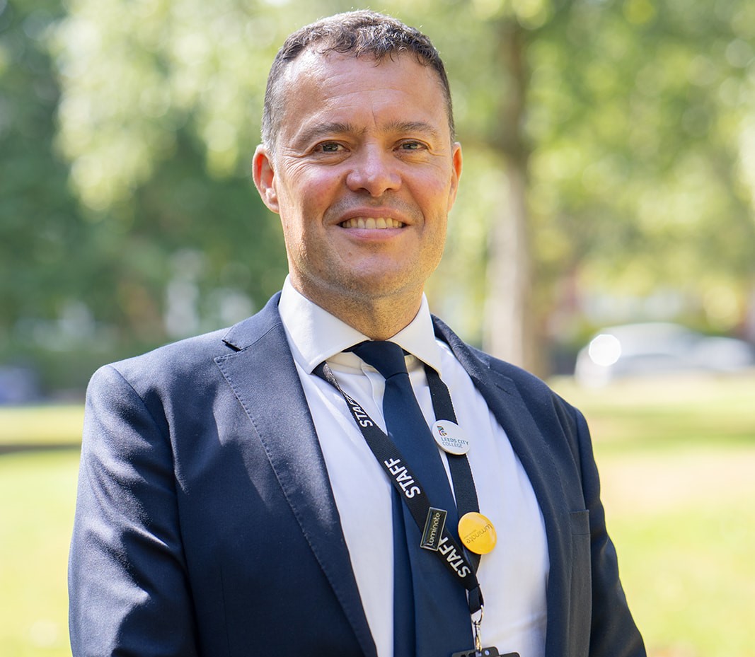 Bill Jones, who has been appointed as the next CEO of Luminate Education Group, standing in a park smiling